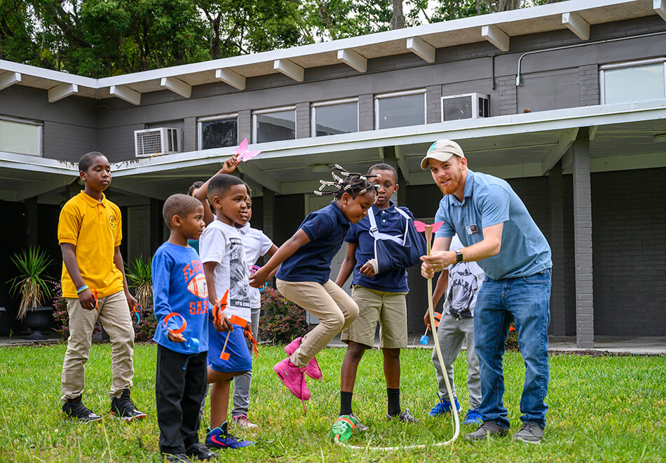 kids interacting with a butterfly demonstration