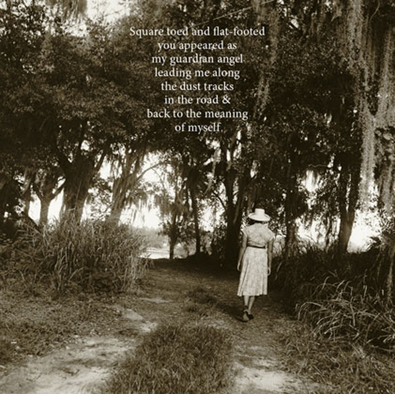 Black and white photograph of a woman in a dress and hat walking away down a dirt path lined with large trees draped in Spanish moss. White text overlaid.