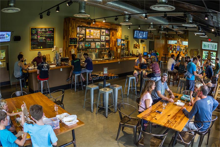 The Wetlands tasting room at Swamp Head Brewery with people