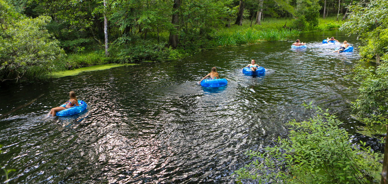 people floating on rafts down the spring fed river at itchetucknee springs state park