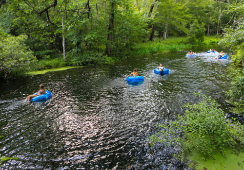 people floating on rafts down the spring fed river at itchetucknee springs state park