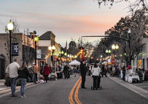 crowd of people shopping along main street in Alachua, Florida