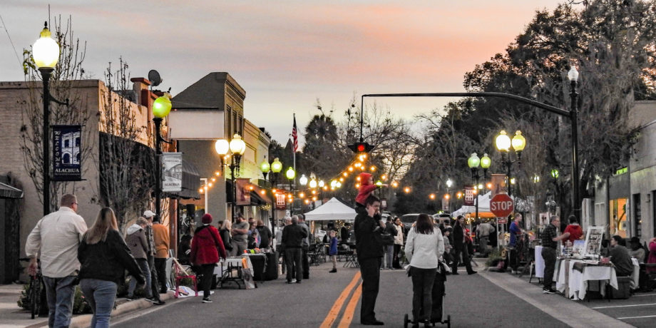crowd of people shopping along main street in Alachua, Florida