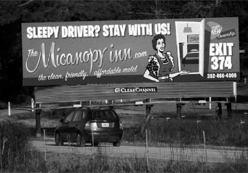 Billboard advertising for The Micanopy Inn that reads Sleepy Driver? Stay with us! Exit 374