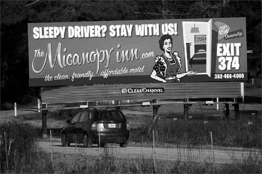 Billboard advertising for The Micanopy Inn that reads Sleepy Driver? Stay with us! Exit 374