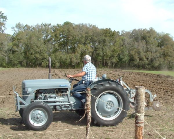 Antique tractor plowing a field