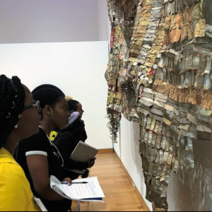 Students take a close look at 'Old Man's Cloth' at the Harn Museum