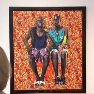 Dr Ann Thebault and Mideley Herard contemplate 'Dogon Couple' oil on canvas by Kehinde Wiley.