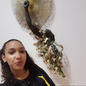 Laquishia Ferguson poses with 'Arm Peace' at the Harn Museum
