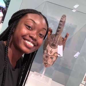 Shaquesha Stallworth poses with Central African mask at the Harn Museum