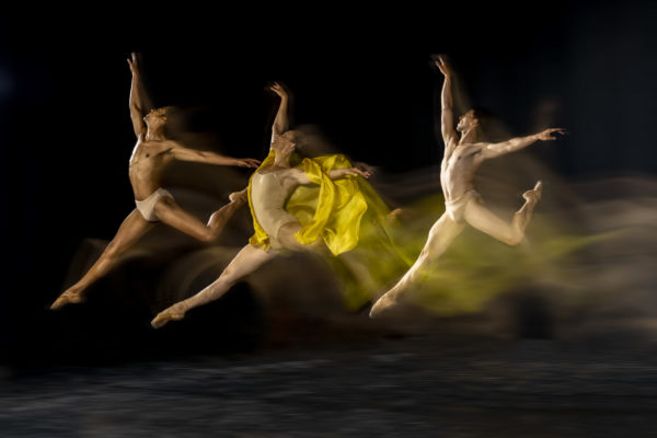 three leaping dancers