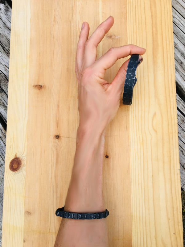 Holding a forged bracelet