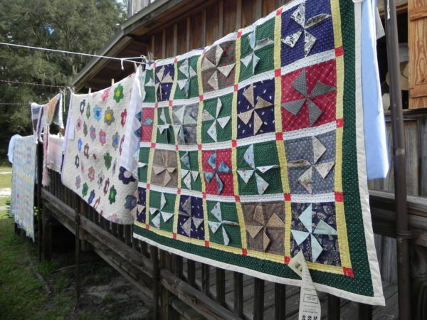 Quilts hanging on clothesline