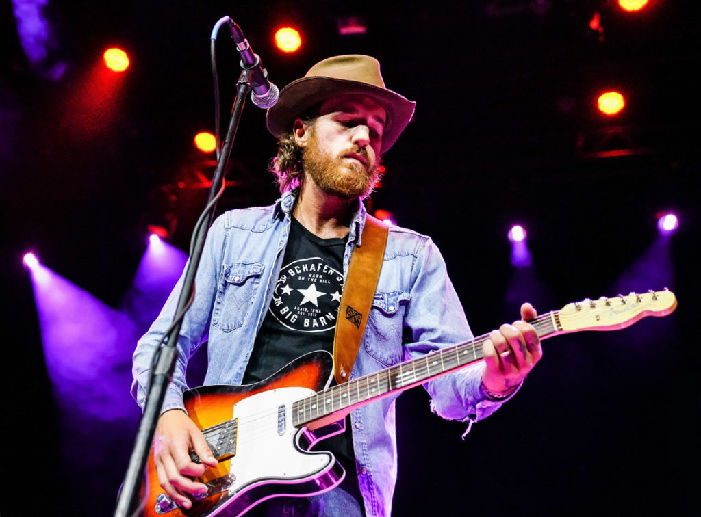 Alex Williams performing with guitar