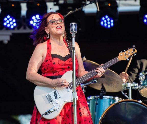 Liz Mandeville on stage with guitar