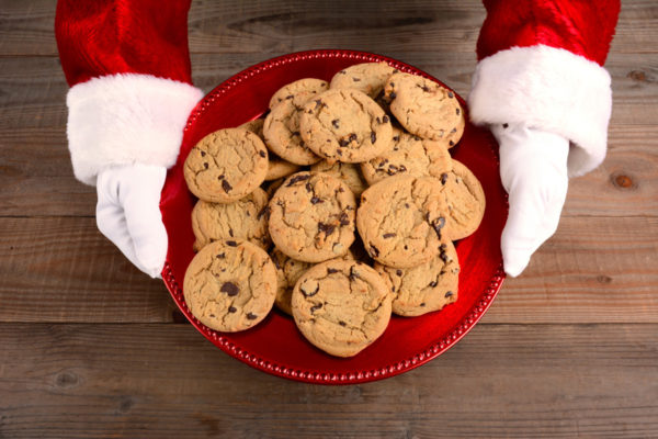 Santa holding a big plate of cookies