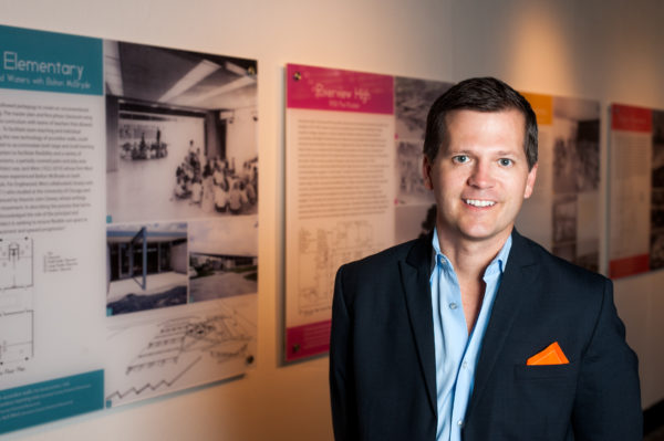 Morris Hylton III in front of exhibit panels
