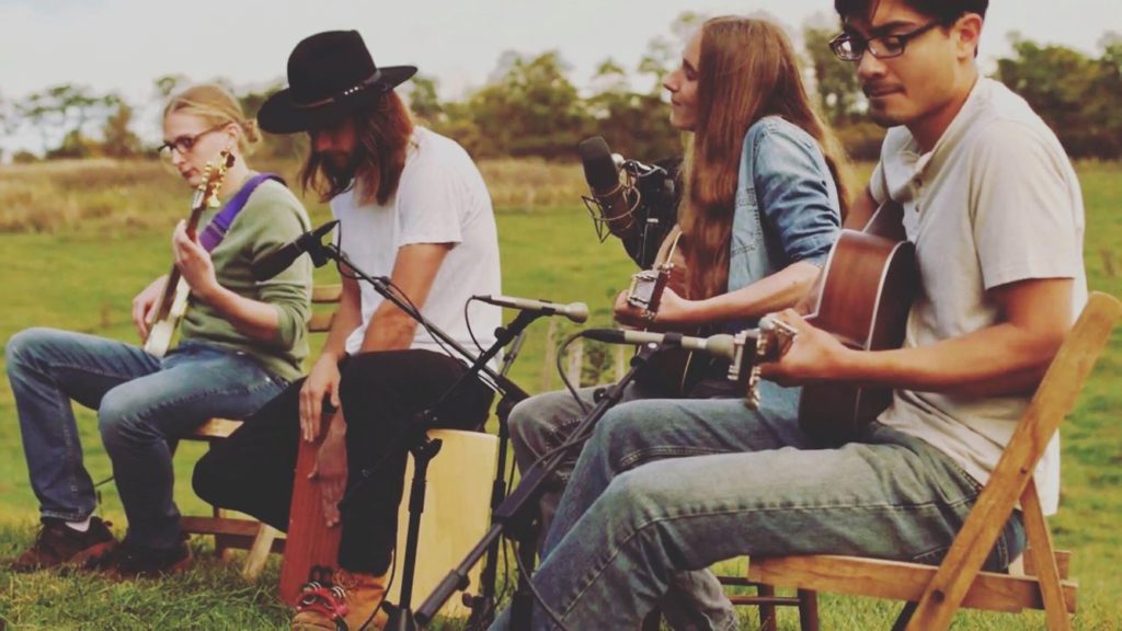 Musican Sawyer Fredericks and musicians with acoustic instruments