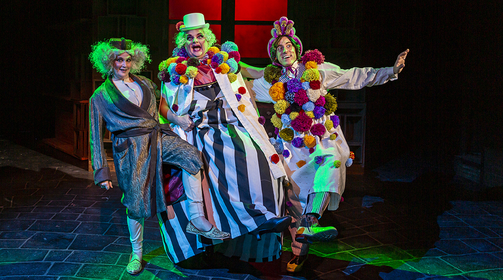 Actors on stage in costume for Scrooge in Rouge at the Hippodrome Theatre