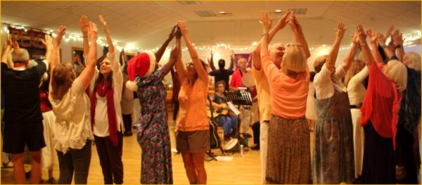 People dancing and reaching up over their heads