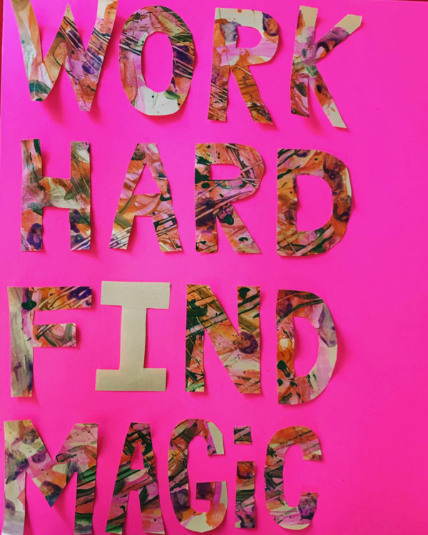 Artistic cut out letters spell out WORK HARD FIND MAGIC