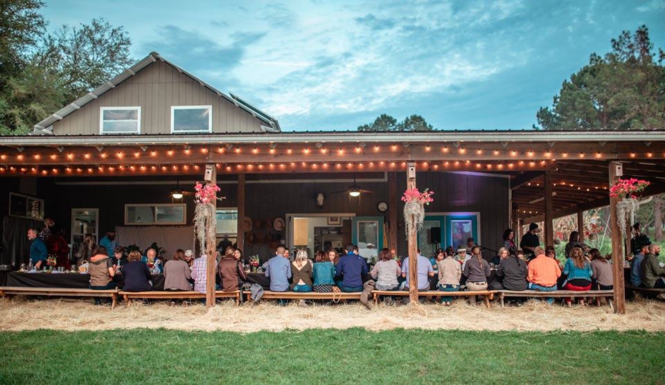 People dining at the Farm Table at Swallowtail Farm