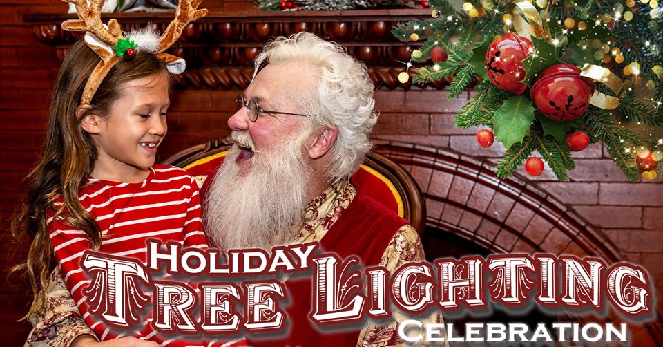 Santa with smiling child at the Holiday Tree Lighting Celebration