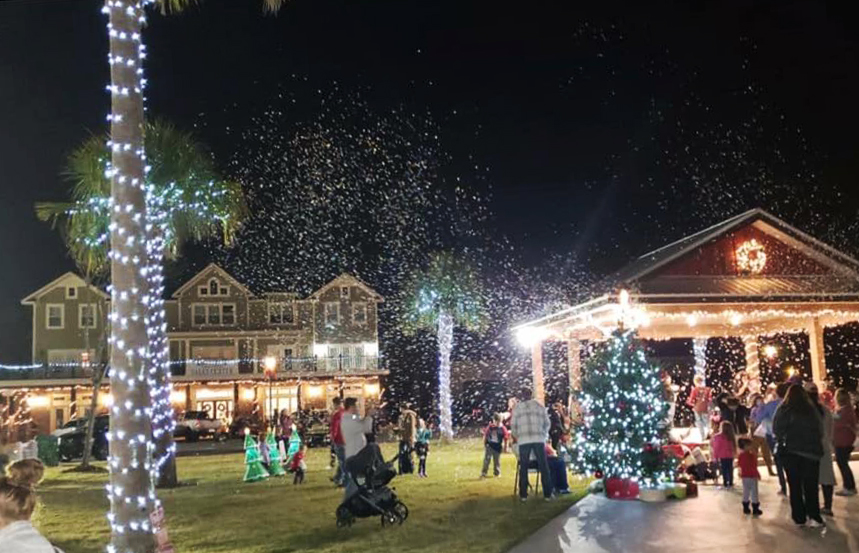 Crowd gathered at CountryWay Town Square with holiday lights and snow machine