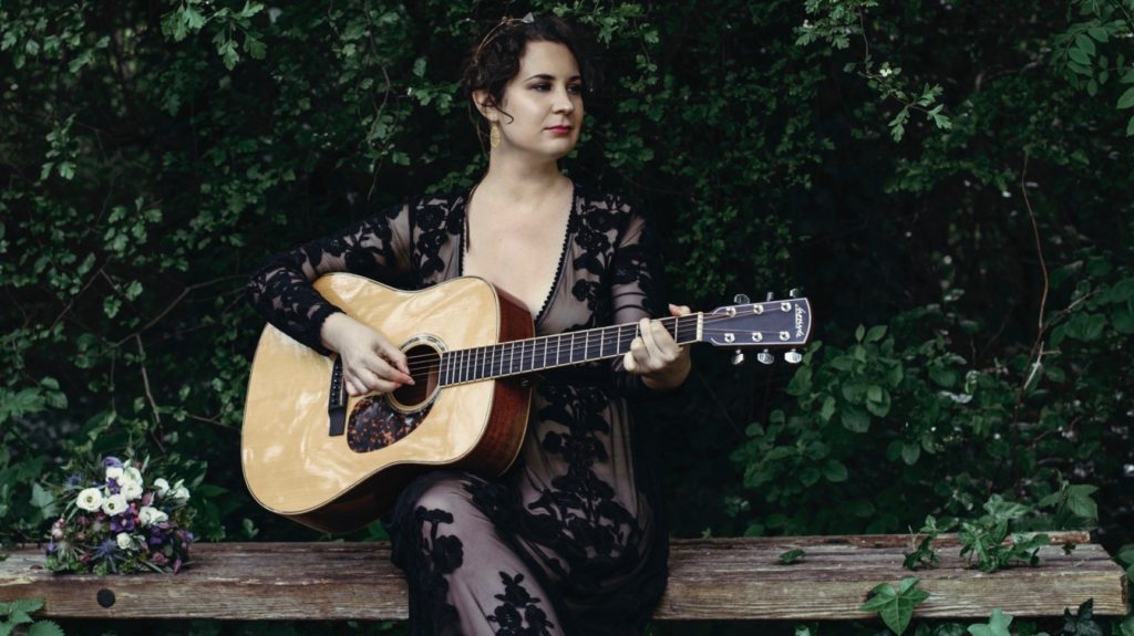 Musician Kyle Carey with guitar