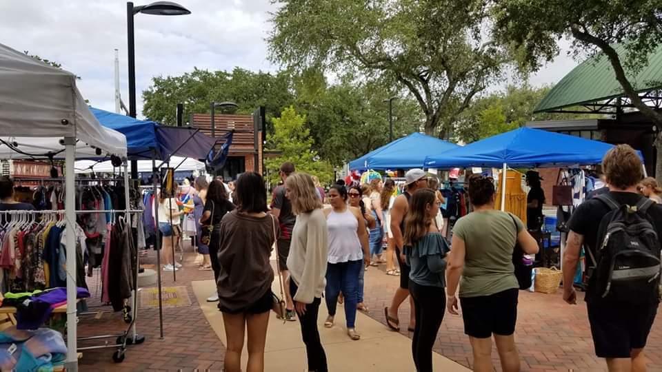 Shoppers browsing vendors at Florida Vintage Market at Bo Diddley Plaza