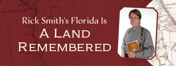 Photo of Rick Smith holding his father's book "A Land Remembered"