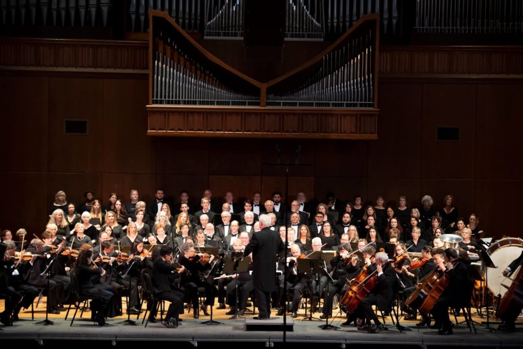Gainesville Master Chorale performing under the pipe organ at University Auditorium