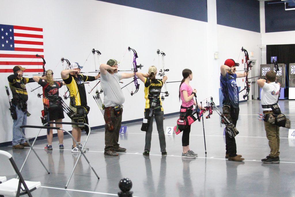 Competitive archers aiming at targets