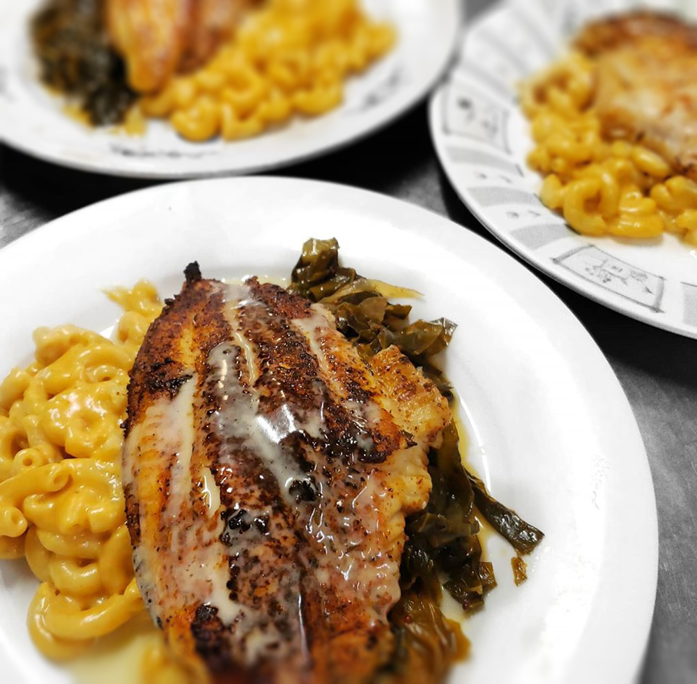 plates of blackened fish, mac and cheese and collard greens from blue gill foods chef carl watts