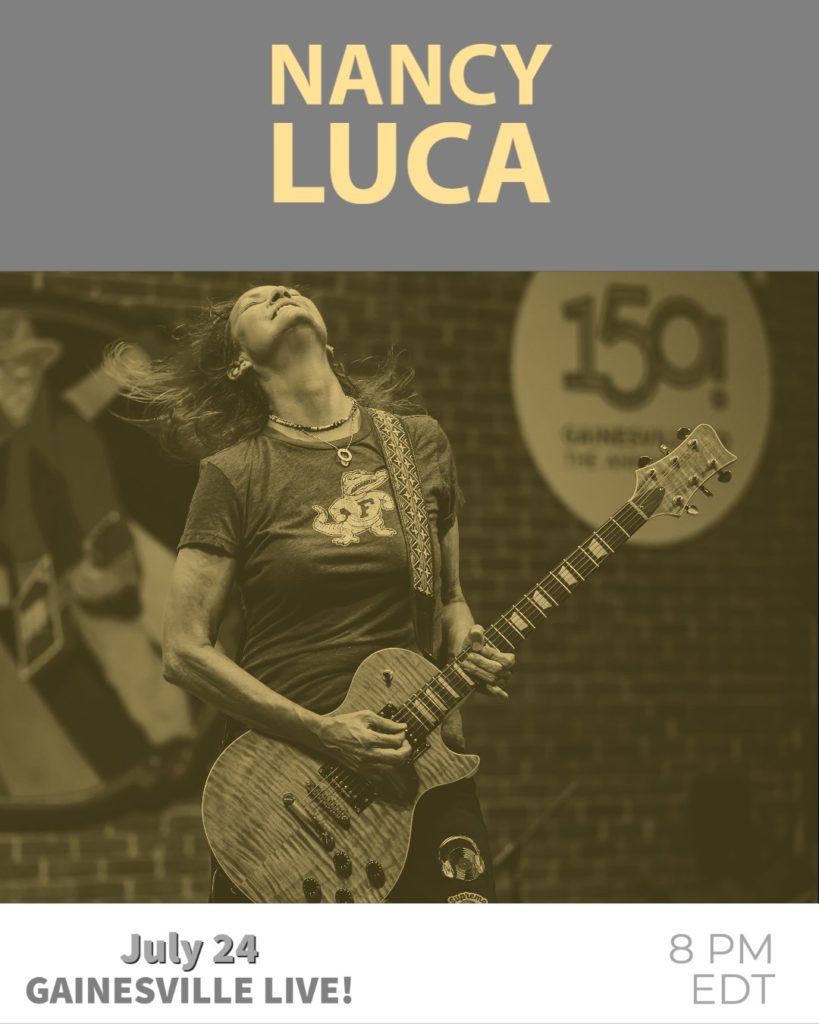 nancy luca performing with guitar