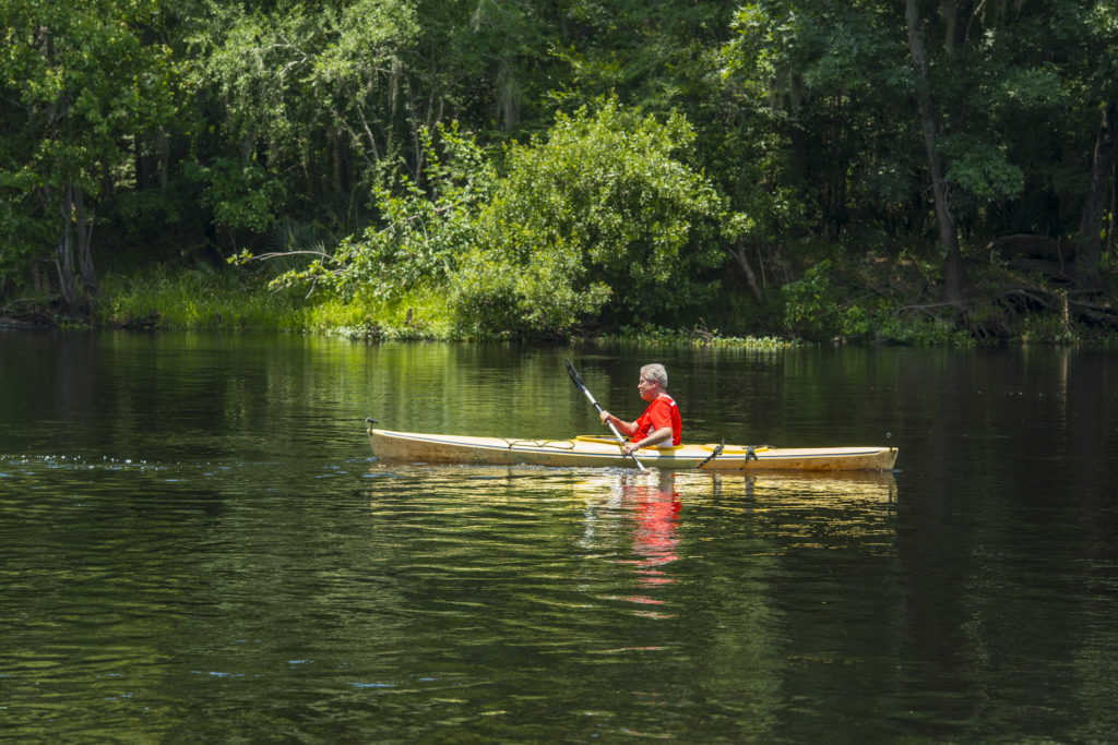 Person paddling in kayak on santa fe river