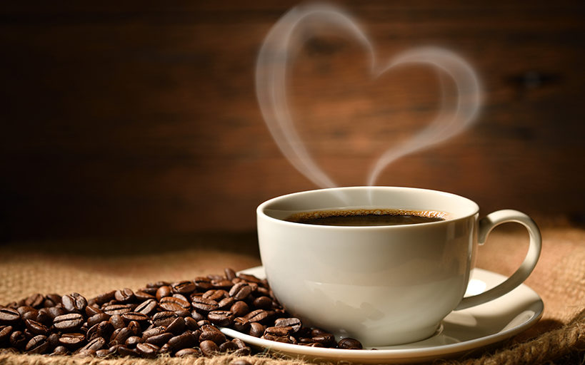 cup of coffee with steam in shape of heart