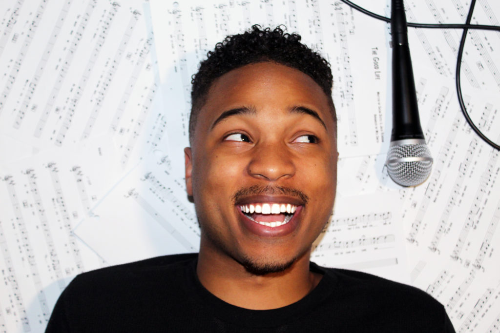 Decyo McDuffie smiling next to microphone
