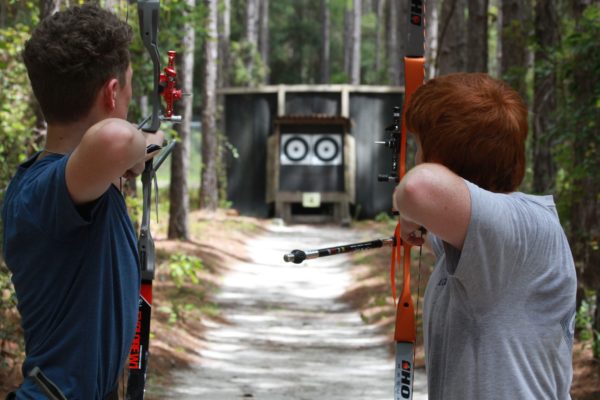 archers taking aim at outdoor targets