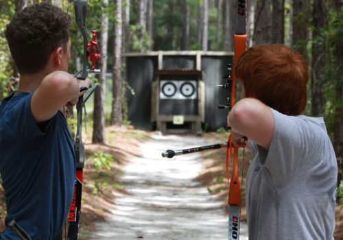 archers aiming at outdoor target