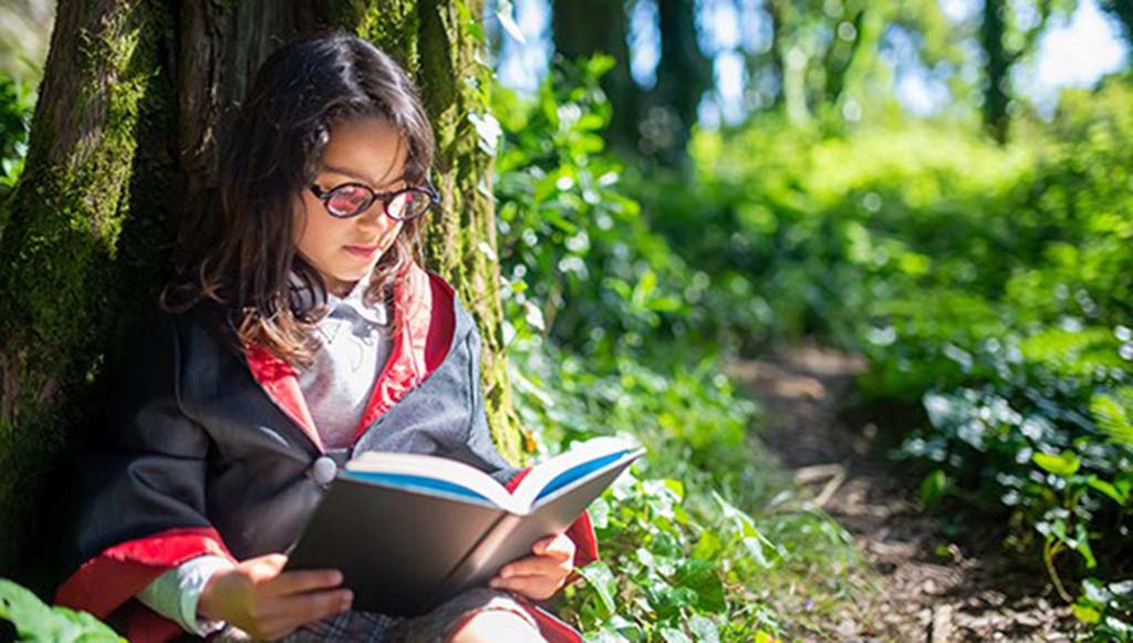 child reading in the park