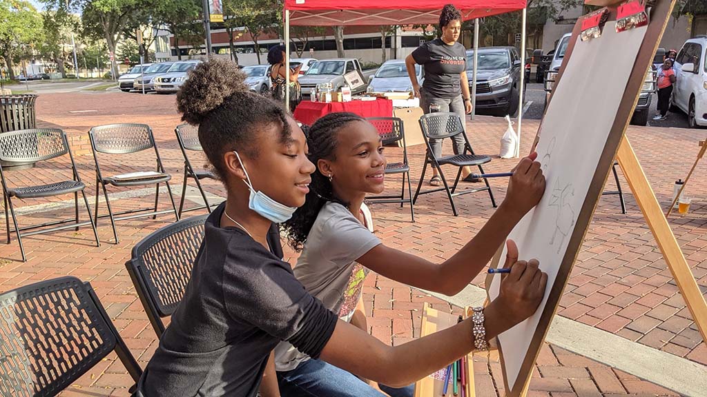 kids drawing on an easel