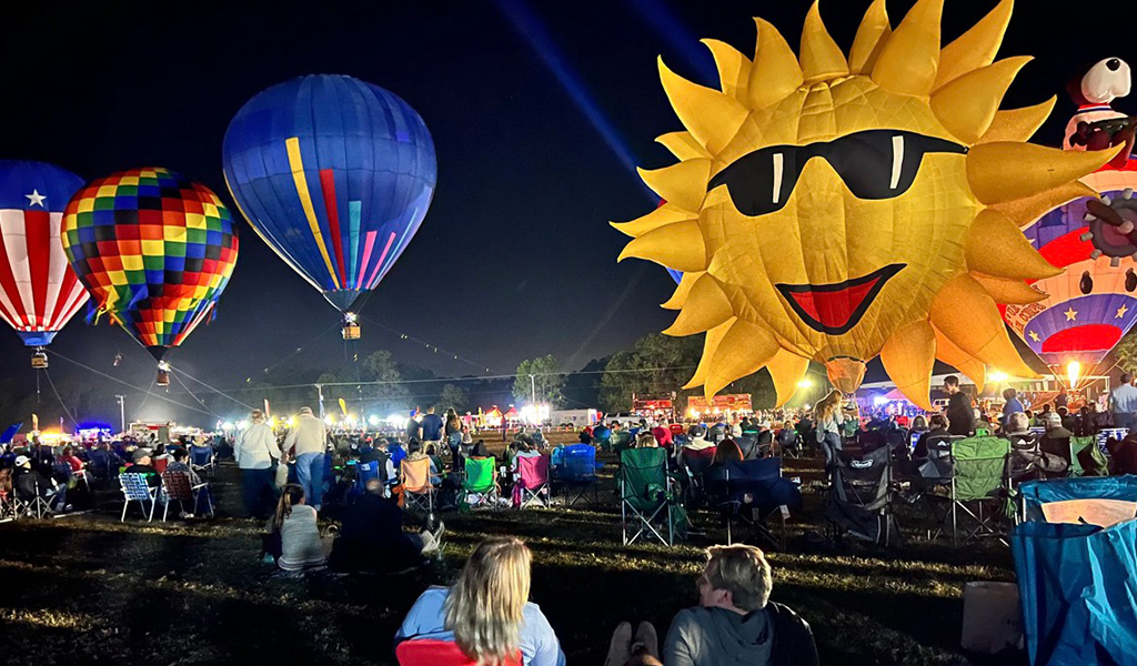 colorful hot air balloons and crowd of people