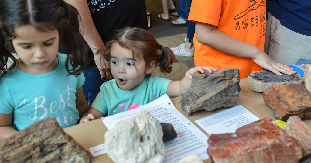 child touching stone samples