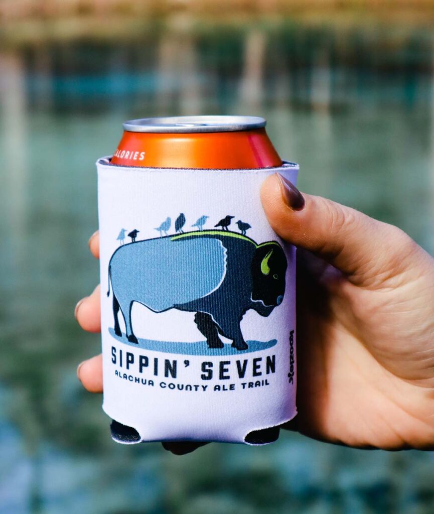 hand holding sippin seven koozie