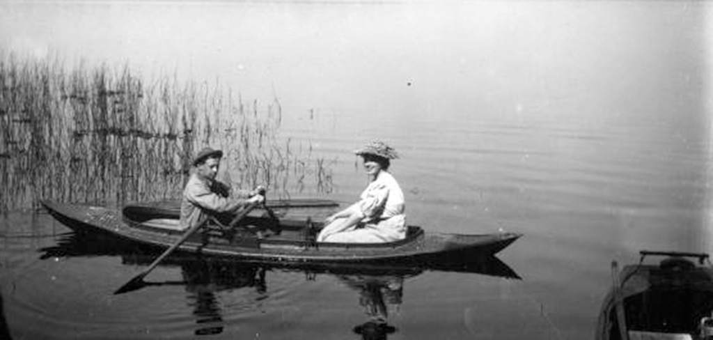 black and white photo of two people in boat
