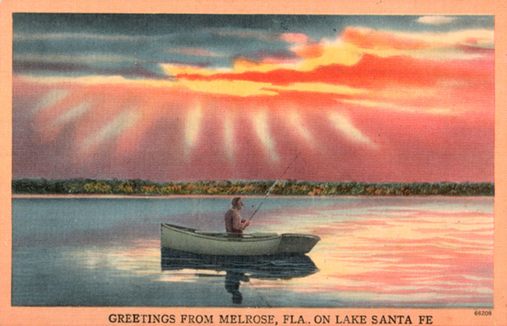 postcard with person in fishing boat on lake