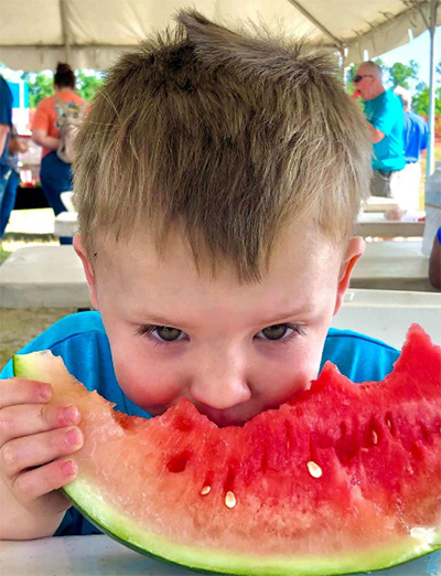 child eating watermelon