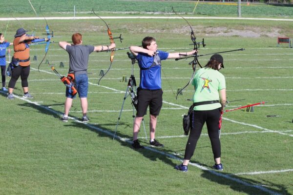 archers aiming on outdoor range