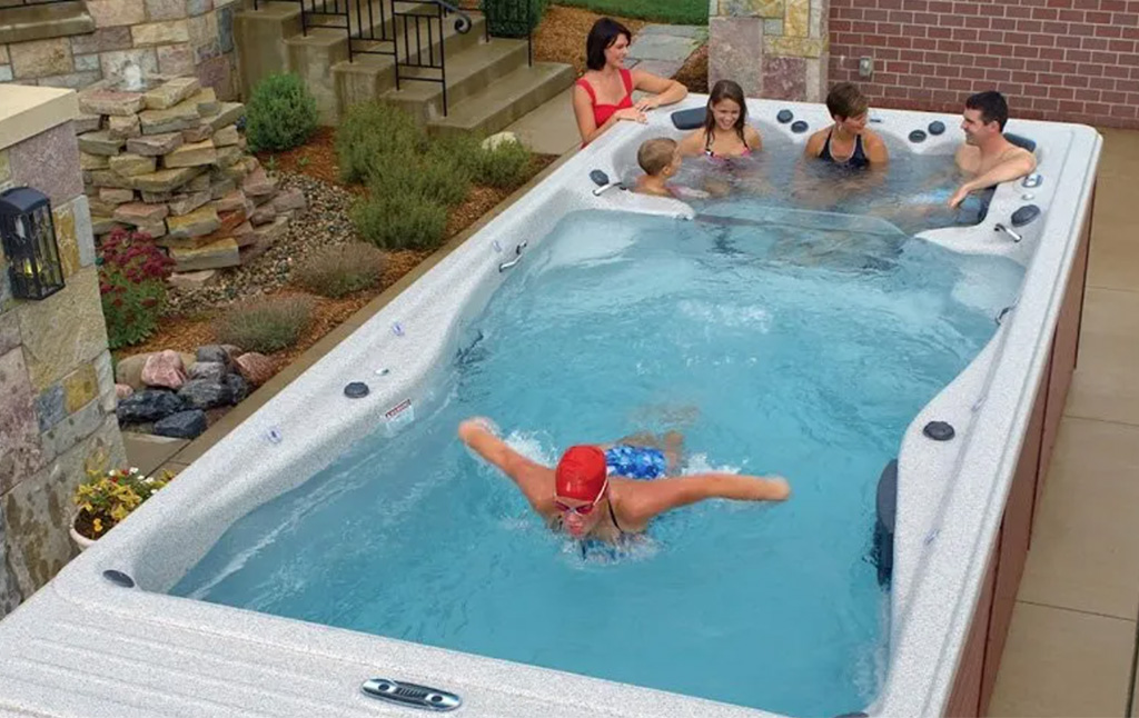 family and swimmer in hot tub